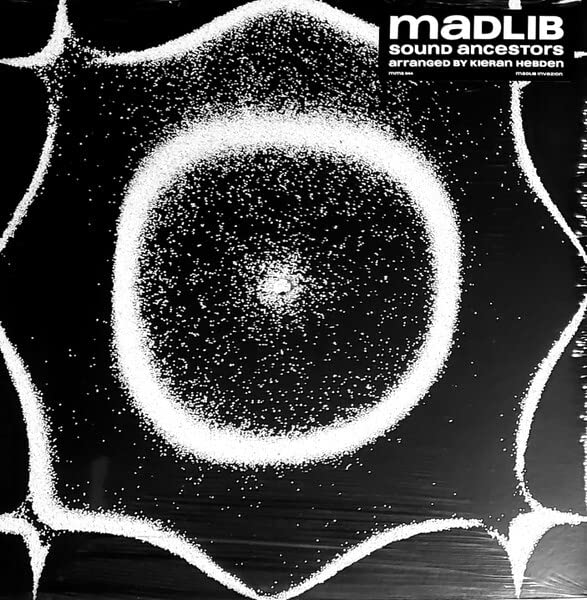 Black and white vinyl record cover with abstract, dotted circular design.