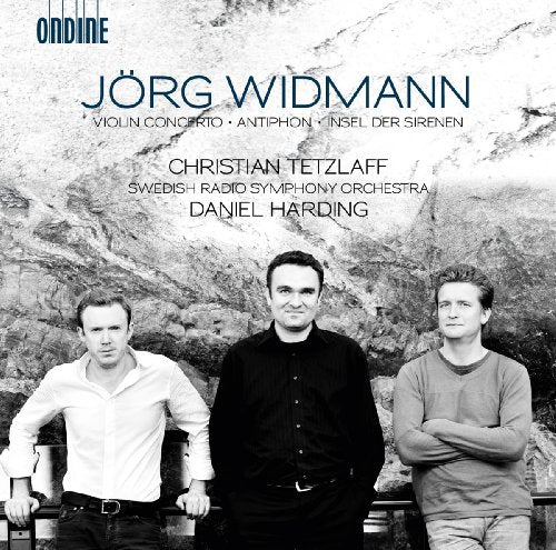 CD cover featuring three musicians and a rocky, grey landscape.
