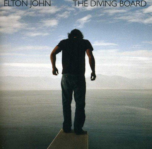 Elton John album cover: man on a diving board, blue sky.