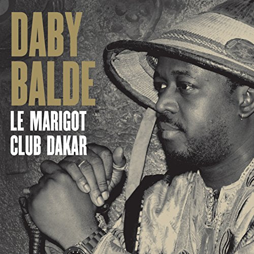 Daby Balde album cover, sepia tone, man with hat and hands clasped.