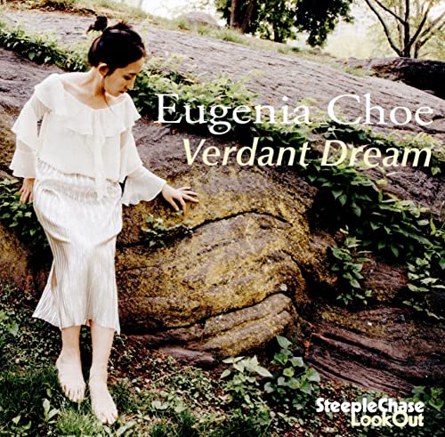 CD cover: woman in white dress near a large rock.