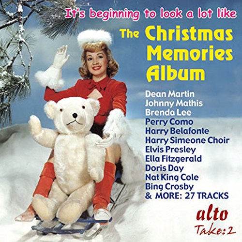 Christmas album cover featuring a woman, bear, and sled, with artist names listed.