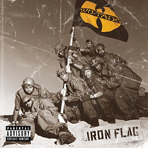 Wu-Tang Clan members in military gear holding a yellow Wu-Tang flag on a beach.