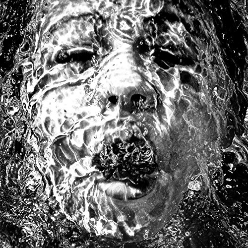 Black and white portrait of a man’s face distorted by water.