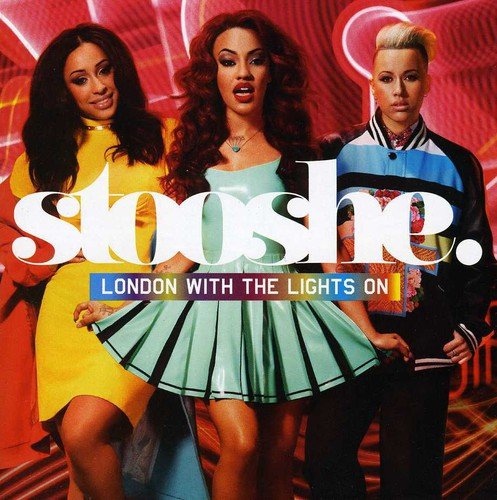 Three women in colorful outfits on a red background with white neon lights.