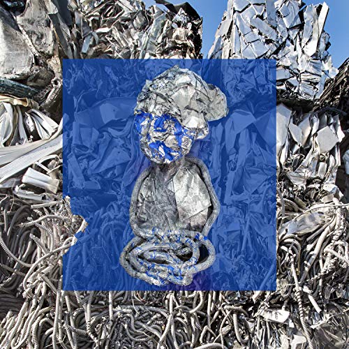 Sculptural bust with blue details, set against a metal scrap background.
