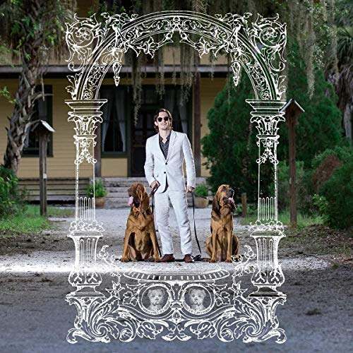 Man in suit with two hounds framed by ornate white archway.