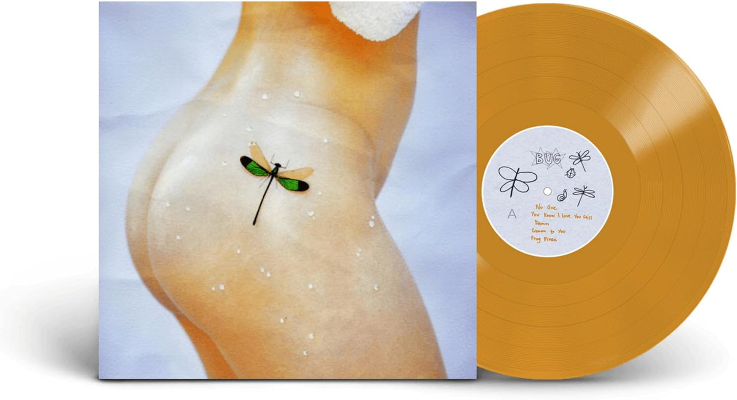 Album cover showing a person's hip with a dragonfly next to a gold vinyl.