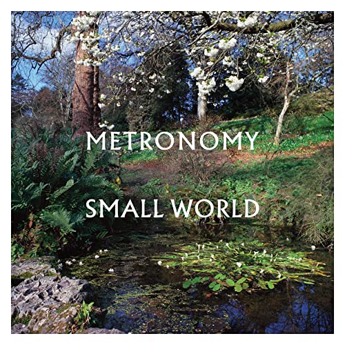 Album cover for Metronomy’s “Small World” featuring a pond and trees.