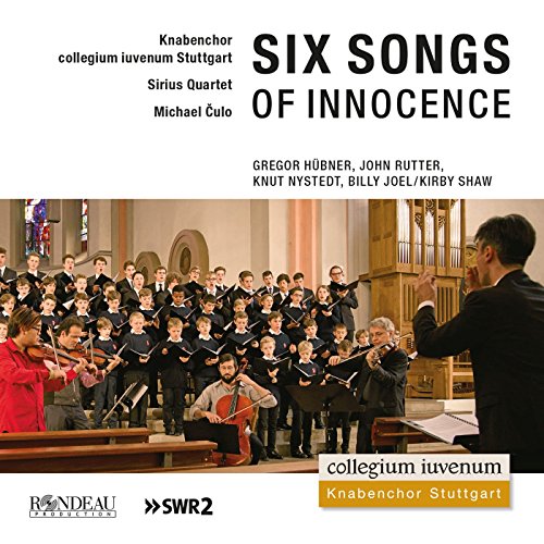 Boys' choir and string quartet performing in a church interior.