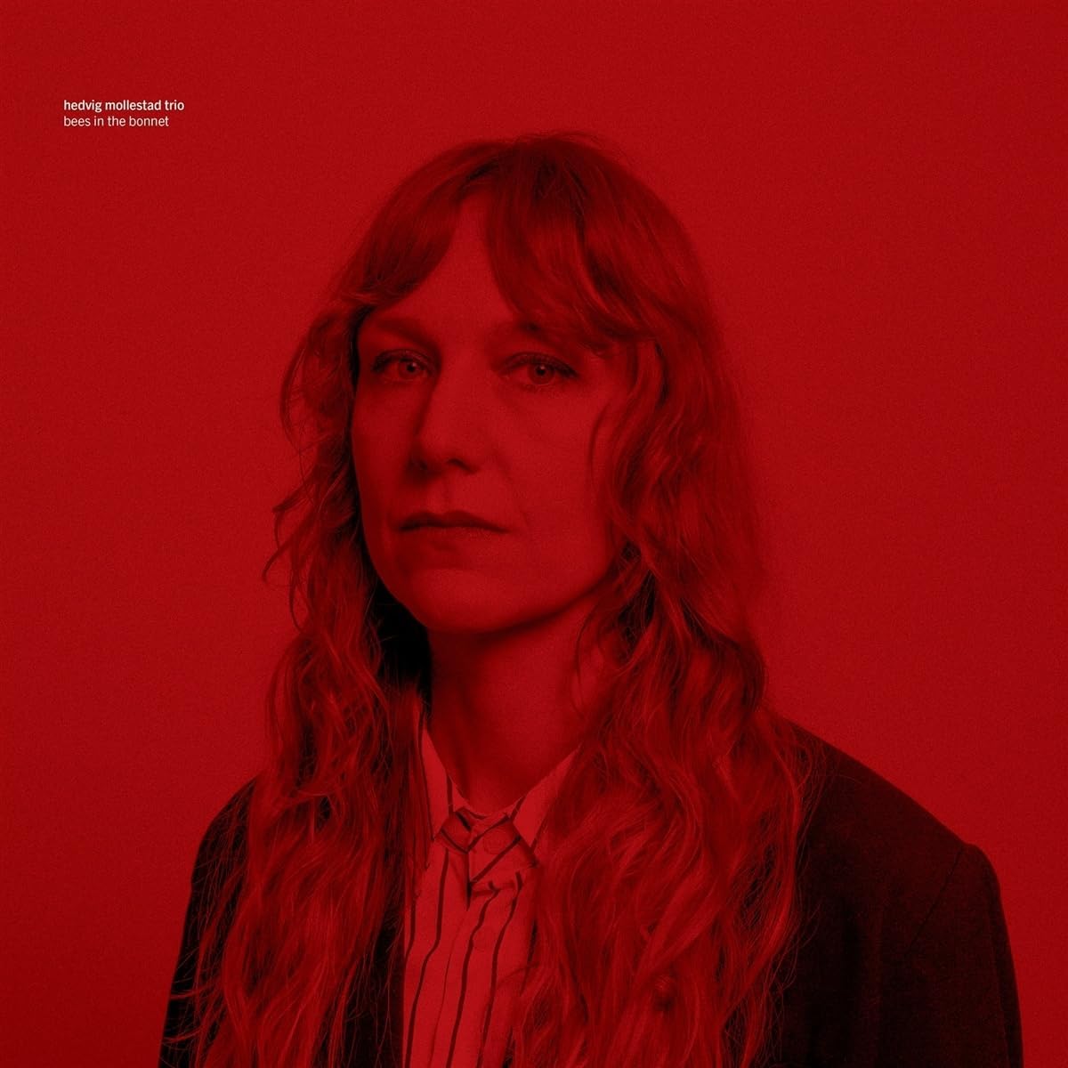 Red album cover featuring a portrait of Hedvig Mollestad with long hair.