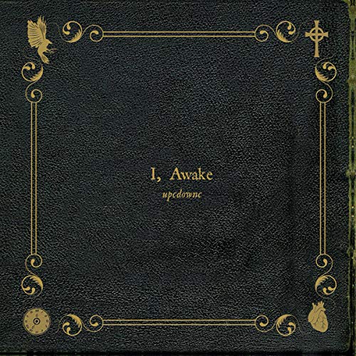 Black vinyl record cover with gold ornate frame and text “I, Awake”.