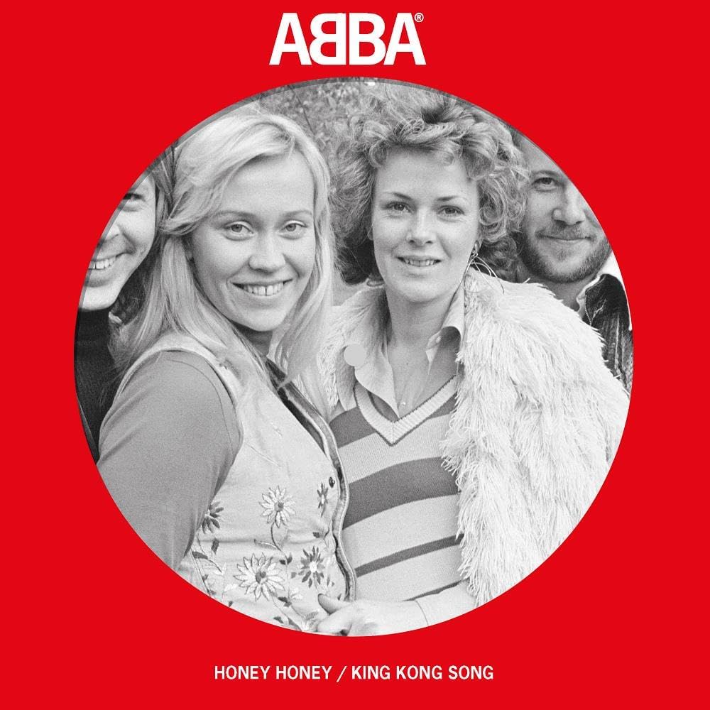 Black and white portrait of ABBA members on a red background.