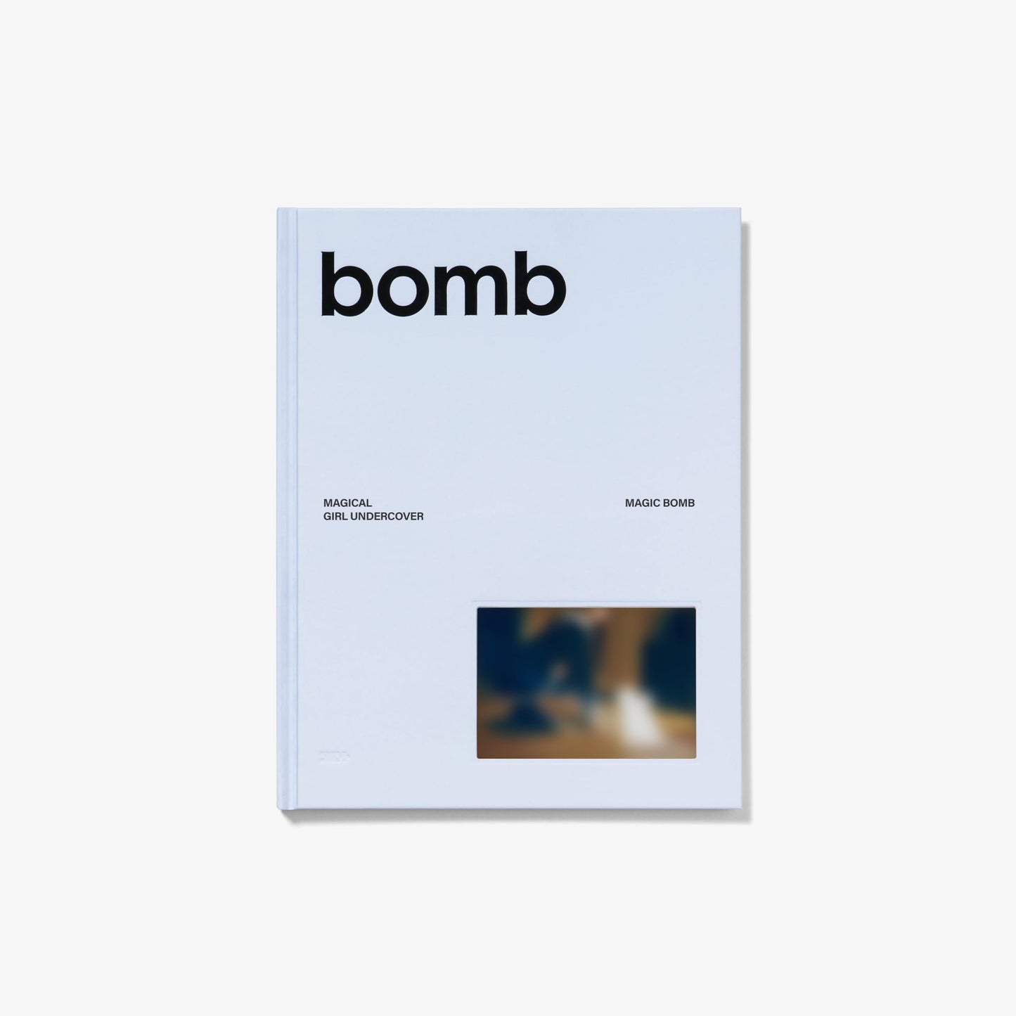 ILLIT "bomb" CD case, light blue with black text and image.