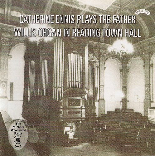 Black and white photo of a large pipe organ in a hall.