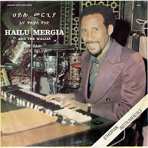 Hailu Mergia at an organ, album cover for "Tche Belew" vinyl record.