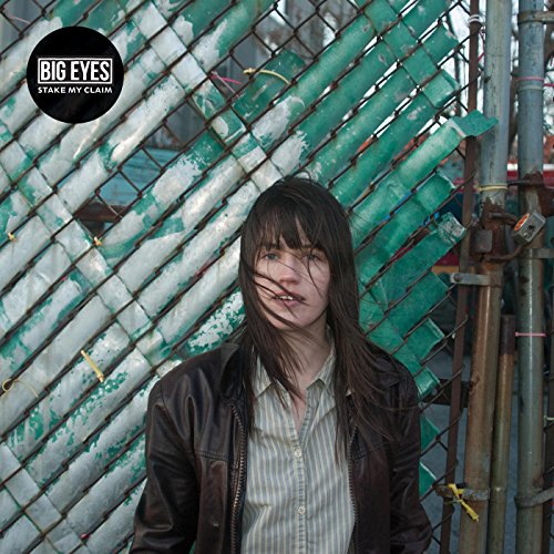 CD cover: woman with long hair in front of green chain-link fence.