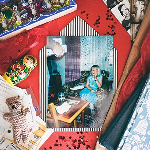 CD cover with collage of photos, toys, and patterned paper.