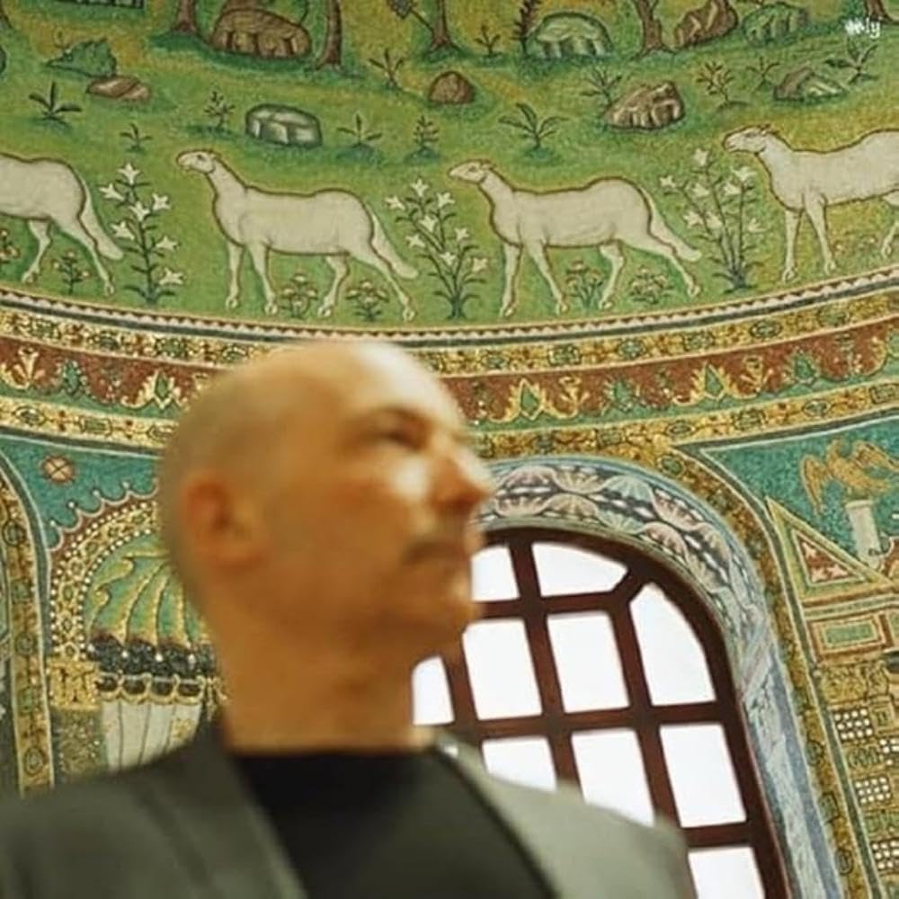 CD cover with mosaic art and a man looking upwards.