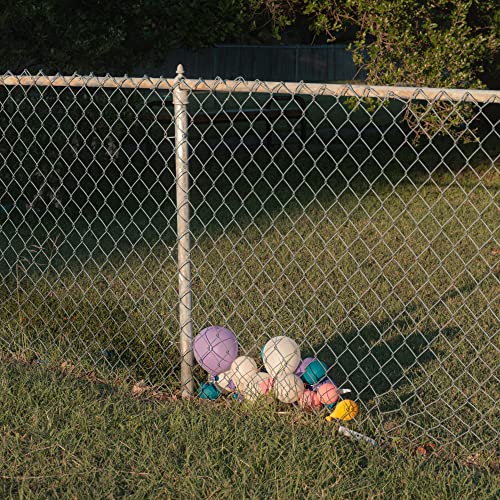 CD cover: deflated balloons tangled in grass near a chain-link fence.