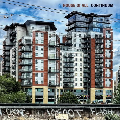 Vinyl album cover: modern apartment buildings against a cloudy sky.