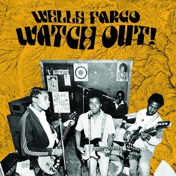 Yellow vinyl record cover featuring a 1970s band in a rehearsal space.