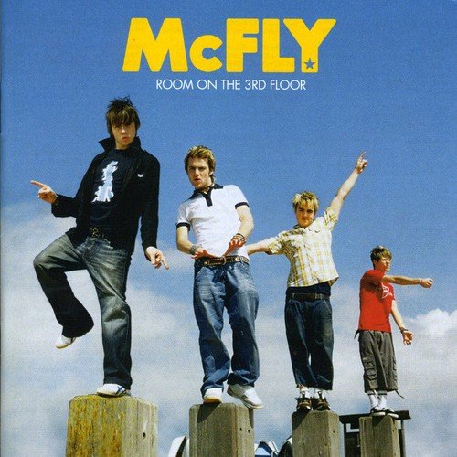 McFly album cover: four young men posing on wooden posts against a blue sky.