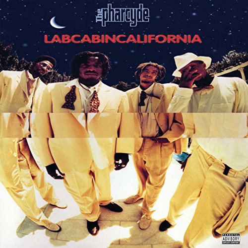 Four men in yellow suits stand against a starry night sky on this album cover.