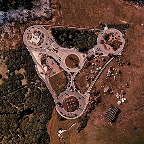 Aerial view of a triangular highway interchange with roundabouts.