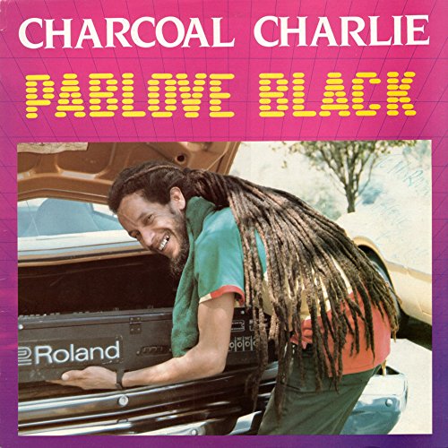 CD cover: man with long dreadlocks leaning on a car with a keyboard.