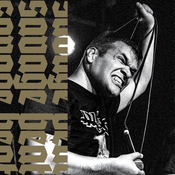 Black and white portrait of a man screaming into a microphone.