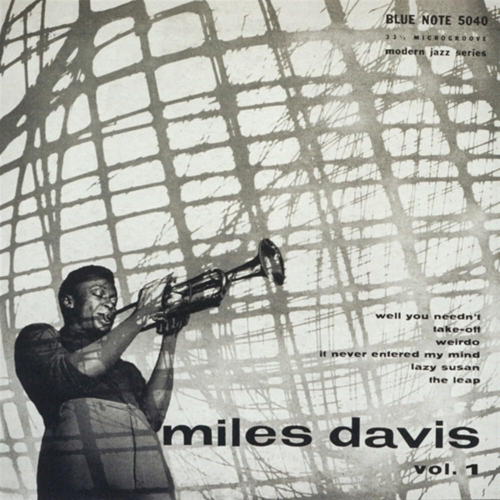 Miles Davis album cover, showing him playing a trumpet through patterned light.