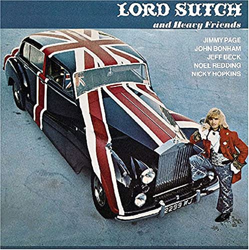 Lord Sutch stands beside a vintage car painted with a Union Jack flag.