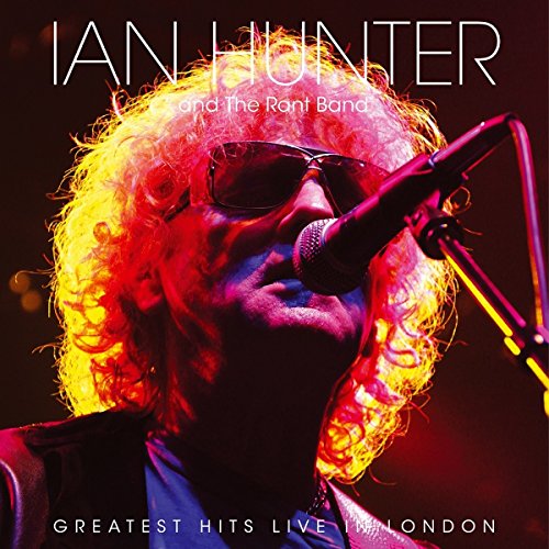 Ian Hunter singing into a microphone with bright, curly hair.