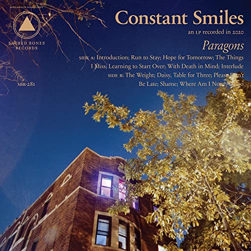 Vinyl record cover with a building silhouette against a twilight sky.