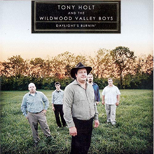 CD cover featuring five men in a field at sunset.