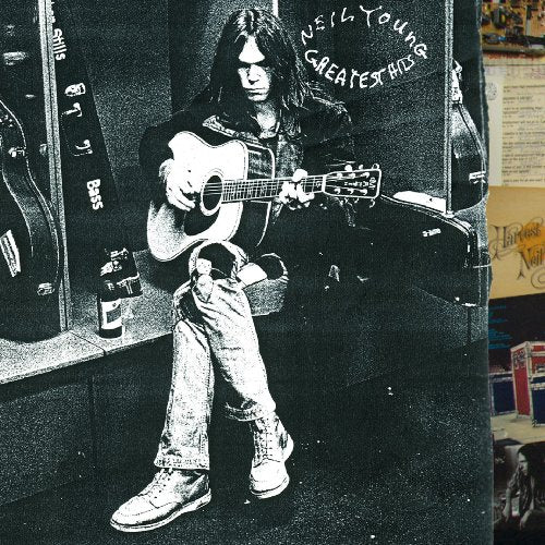 Neil Young playing acoustic guitar on album cover, black and white.