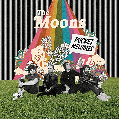 Four band members sit on grass before a colorful rainbow and black-and-white striped background.