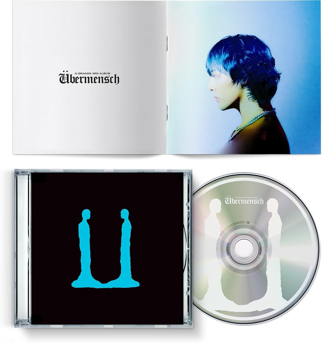 G-Dragon’s “Übermensch” CD album open with portrait and disc inside.
