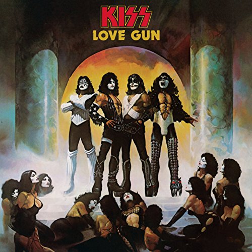 The band Kiss stands in makeup and costumes before a crowd of kneeling women.