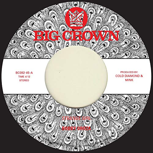 7-inch vinyl record label with peacock feather design and red text.