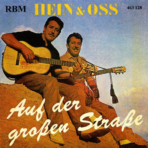 Two men with guitars sit on a sandy hill, album cover.