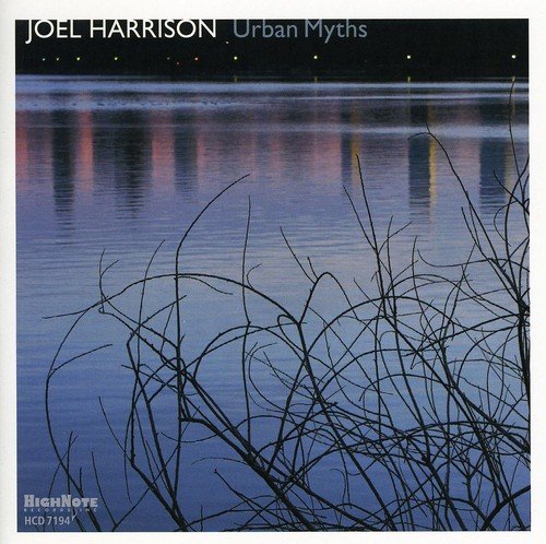CD cover: water reflecting city lights, with foreground branches.