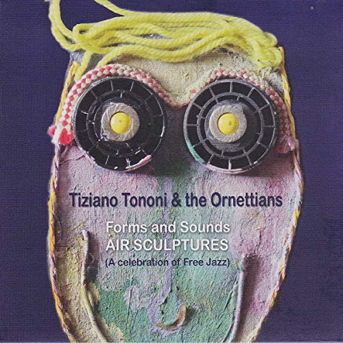 CD cover with textured, colorful mask featuring large circular eyes.