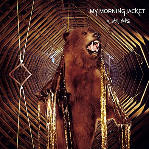 Album cover: bear in a geometric, wooden-paneled room.