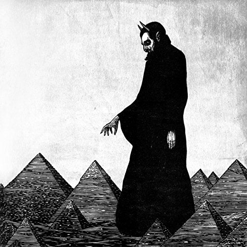 Black and white illustration of a cloaked figure before pyramids.