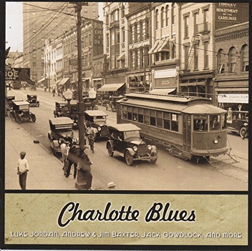 Vintage street scene with trolley car and text āCharlotte Bluesā.