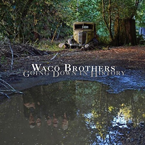 Album cover: The Waco Brothers - Going Down in History, rusty car in woods.