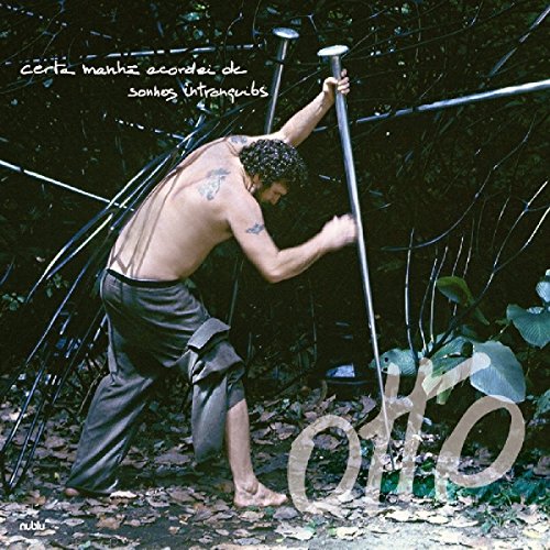 CD cover: man with tattoos in a lush, overgrown landscape.