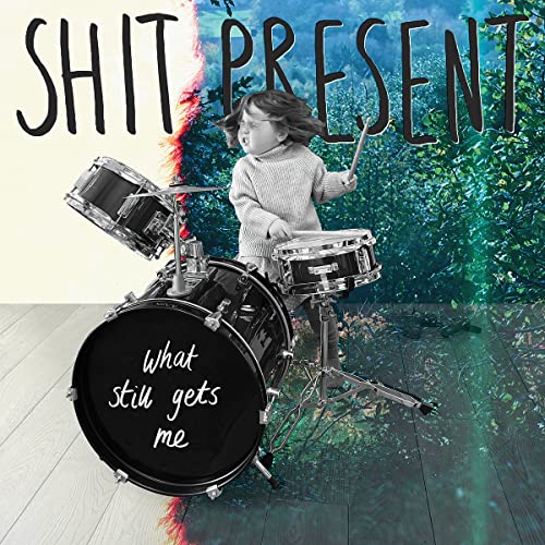 Child playing drums with album title "Shit Present" overlaid.